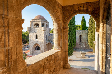 View of belfry of Monastery of Filerimos and small water well on Acropolis of Ialyssos (Rhodes,...