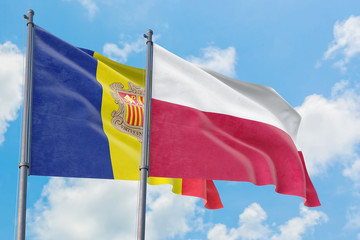 Poland and Andorra flags waving in the wind against white cloudy blue sky together. Diplomacy concept, international relations.