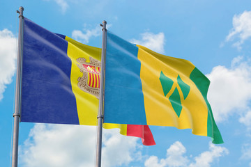 Saint Vincent And The Grenadines and Andorra flags waving in the wind against white cloudy blue sky...
