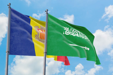 Saudi Arabia and Andorra flags waving in the wind against white cloudy blue sky together. Diplomacy concept, international relations.