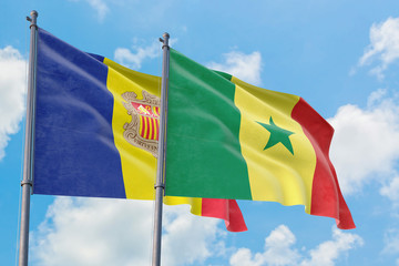 Senegal and Andorra flags waving in the wind against white cloudy blue sky together. Diplomacy concept, international relations.