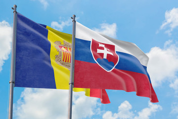 Slovakia and Andorra flags waving in the wind against white cloudy blue sky together. Diplomacy concept, international relations.