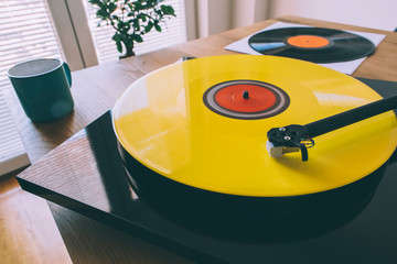 Turntable with yellow vinyl record playing