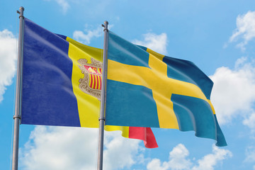 Sweden and Andorra flags waving in the wind against white cloudy blue sky together. Diplomacy concept, international relations.