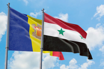 Syria and Andorra flags waving in the wind against white cloudy blue sky together. Diplomacy...