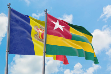 Togo and Andorra flags waving in the wind against white cloudy blue sky together. Diplomacy concept, international relations.