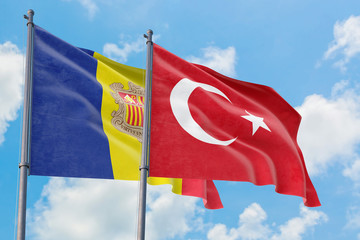 Turkey and Andorra flags waving in the wind against white cloudy blue sky together. Diplomacy concept, international relations.