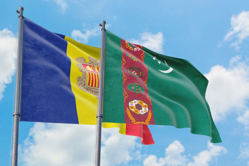 Turkmenistan and Andorra flags waving in the wind against white cloudy blue sky together. Diplomacy concept, international relations.