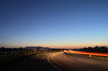 Car zooming in the Sunset