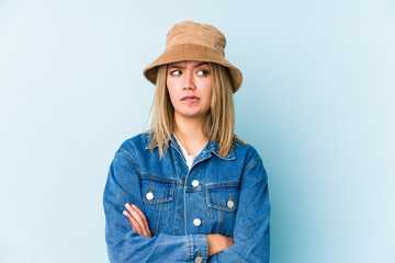 Young blonde caucasian woman isolated unhappy looking in camera with sarcastic expression.