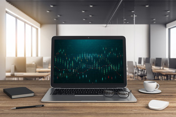 Laptop on wooden desk with chart on screen