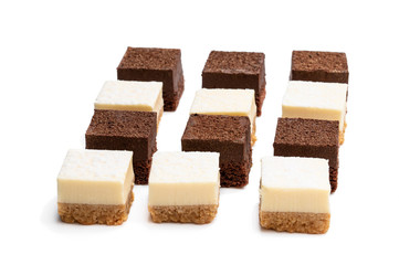 Set of mini chocolate and vanilla cheesecake bites isolated on white