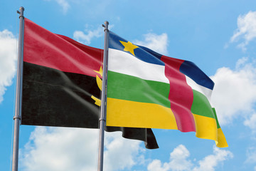 Central African Republic and Angola flags waving in the wind against white cloudy blue sky together. Diplomacy concept, international relations.
