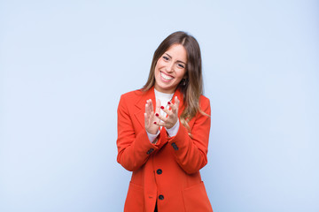young pretty hispanic woman feeling happy and successful, smiling and clapping hands, saying...