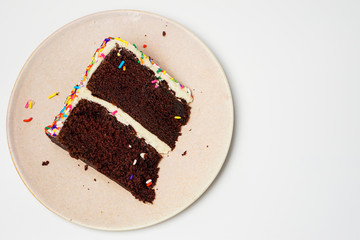 piece of chocolate cake on a plate isolated on white