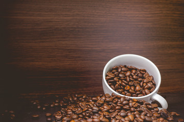 Warm coffee on a wooden plate backgrounds. Vintage backgrounds, Beans backgrounds. Copy space menu.