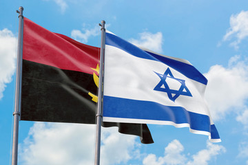 Israel and Angola flags waving in the wind against white cloudy blue sky together. Diplomacy concept, international relations.