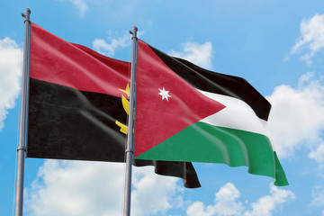 Jordan and Angola flags waving in the wind against white cloudy blue sky together. Diplomacy concept, international relations.