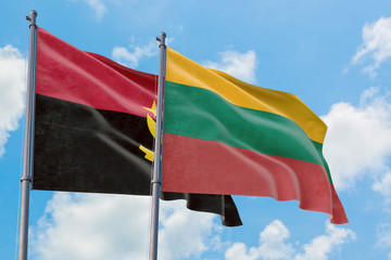 Lithuania and Angola flags waving in the wind against white cloudy blue sky together. Diplomacy concept, international relations.