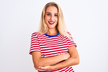 Young beautiful woman wearing red striped t-shirt standing over isolated white background happy face smiling with crossed arms looking at the camera. Positive person.