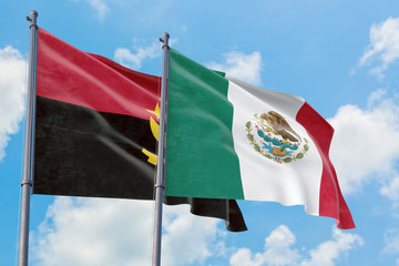 Mexico and Angola flags waving in the wind against white cloudy blue sky together. Diplomacy concept, international relations.