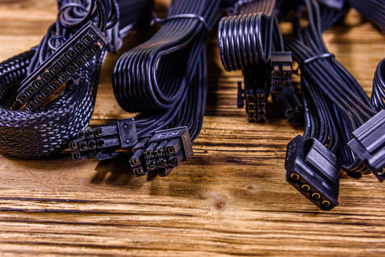 Set of computer psu cables on a wooden background