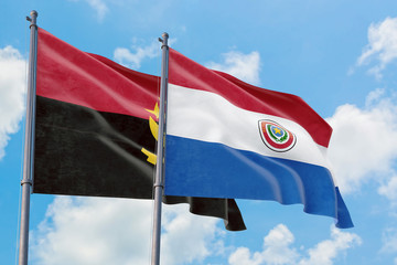 Paraguay and Angola flags waving in the wind against white cloudy blue sky together. Diplomacy concept, international relations.