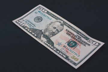 Fifty dollars banknote, isolated on black background, place for inscription.