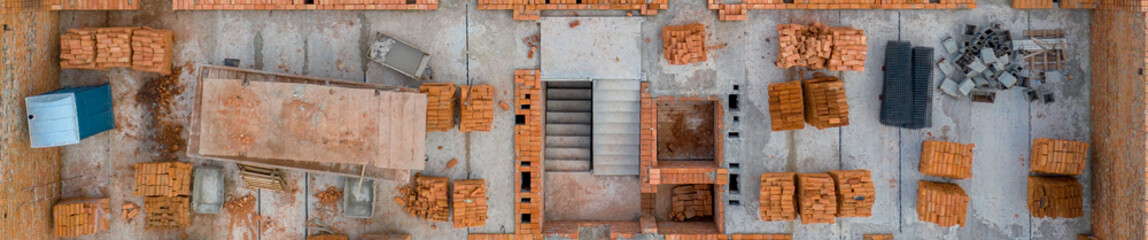 Pallets of clay brick stored for building construction. Construction site background. Top view, ndustrial background