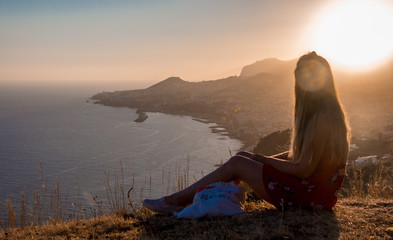 Fototapeta na wymiar Sunset view person hiking madeira miradouro looking over bay of Funchal outdoor traveling concept