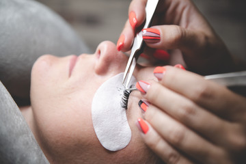 Process of eyelash extensions in the beauty studio. Process close up. Beauty and care for yourself....