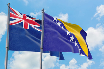 Bosnia Herzegovina and Anguilla flags waving in the wind against white cloudy blue sky together. Diplomacy concept, international relations.