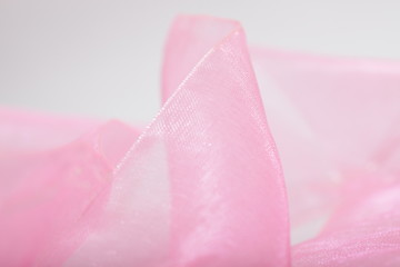 Pink satin ribbon texture for background / wallpaper