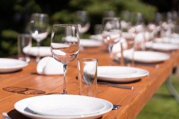 Served wooden table without a tablecloth. Cafe in the open air park