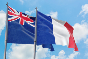 France and Anguilla flags waving in the wind against white cloudy blue sky together. Diplomacy concept, international relations.