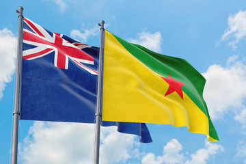 French Guiana and Anguilla flags waving in the wind against white cloudy blue sky together. Diplomacy concept, international relations.