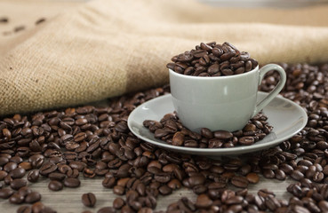 Roasted coffee beans in a coffee mug