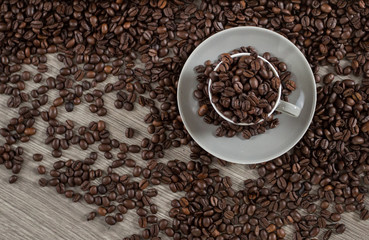 Roasted coffee beans in a caffee mug