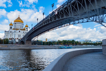 Moscow. Russia. Cathedral of Christ the Savior. The bridge to the temple across the river. Pedestrian bridge over the Moscow river. Moscow in summer turf. Russian city on a background of blue sky.