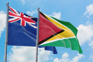 Guyana and Anguilla flags waving in the wind against white cloudy blue sky together. Diplomacy concept, international relations.