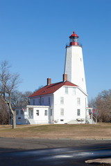 Fototapeta na wymiar A view of the newly refreshed and painted Sandy Hook Lighthouse at Fort Hancock in Sandy Hook, New Jersey. Photo taken during January, 2020.