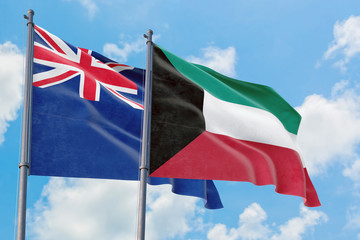Kuwait and Anguilla flags waving in the wind against white cloudy blue sky together. Diplomacy concept, international relations.