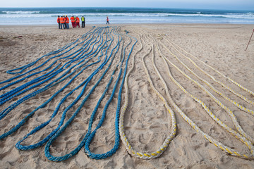 Ropes collected on beach for use by teams to pull fiber optic cable ashore