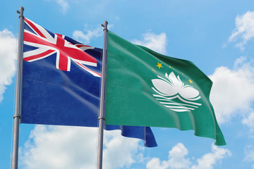 Macao and Anguilla flags waving in the wind against white cloudy blue sky together. Diplomacy concept, international relations.