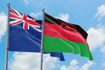 Malawi and Anguilla flags waving in the wind against white cloudy blue sky together. Diplomacy concept, international relations.