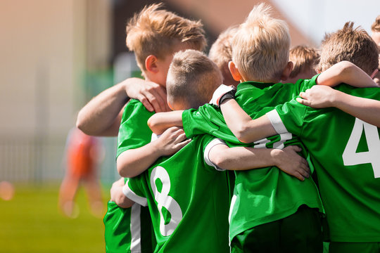 Happy Sports Boys in a School Team. Kids Huddling in a Team on Tournament Competition Before the Final Match. Players Gathering Together in a Circle to Strategize and Motivate © matimix