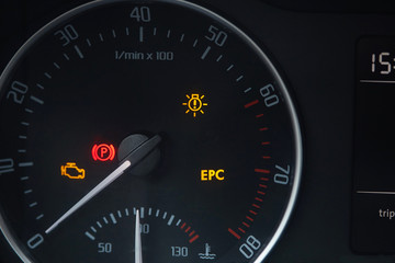 Tachometer dial with needle showing zero rpm with diagnostic icons isolated on black background