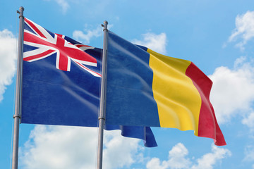 Romania and Anguilla flags waving in the wind against white cloudy blue sky together. Diplomacy concept, international relations.