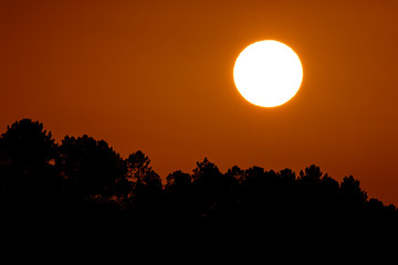 sun hiding behind the horizon