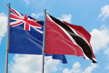 Trinidad And Tobago and Anguilla flags waving in the wind against white cloudy blue sky together. Diplomacy concept, international relations.